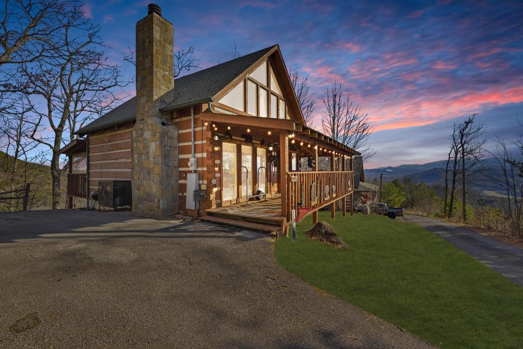 a log cabin with a porch and a chimney at Somewhere In Time cabin in Sevierville