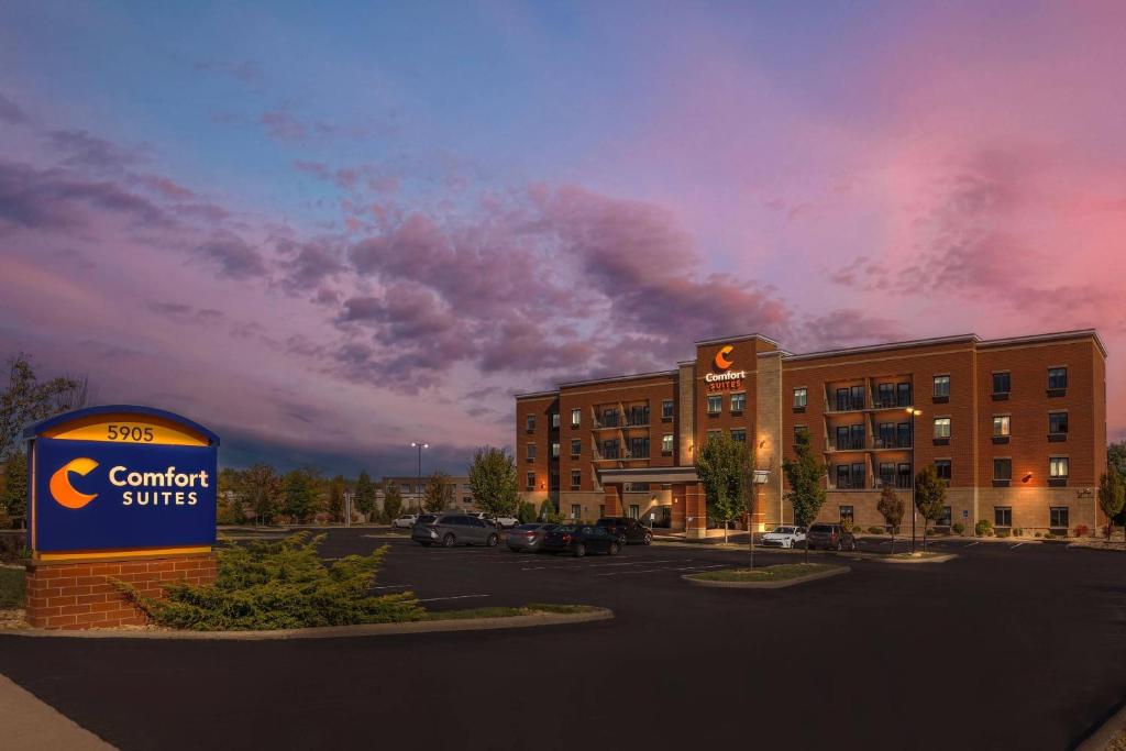 a building with a sign in front of a parking lot at Comfort Suites Florence - Cincinnati South in Florence