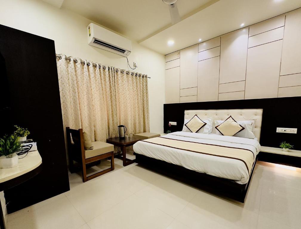 a bedroom with a large bed and a desk at Abu Inn, Mount Abu - The Luxury Boutique Stay in Mount Ābu