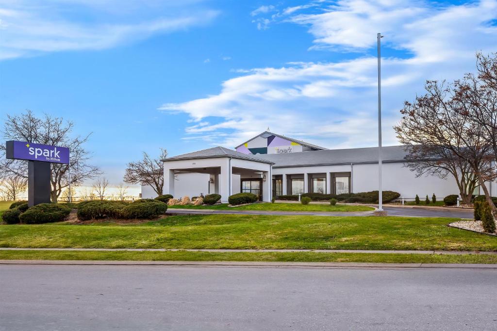 a white building with a sign in front of it at Spark by Hilton Bettendorf Quad Cities in Bettendorf