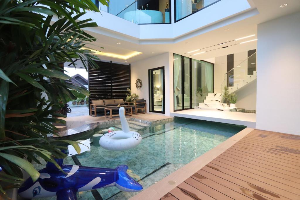 a swimming pool in the middle of a house at Indiluxe pool villa in Pattaya South