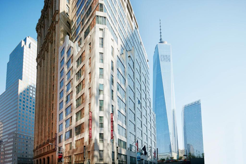 a tall building in a city with tall buildings at World Center Hotel in New York