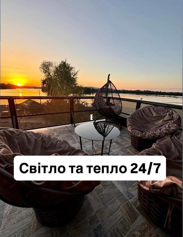 a view of a sunset from a balcony with a table at Shtil in Kyiv