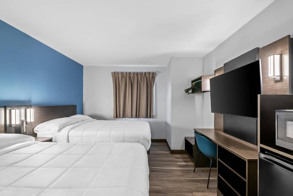 a hotel room with two beds and a tv at Park Inn by Radisson, Grand Island I-80 in Grand Island