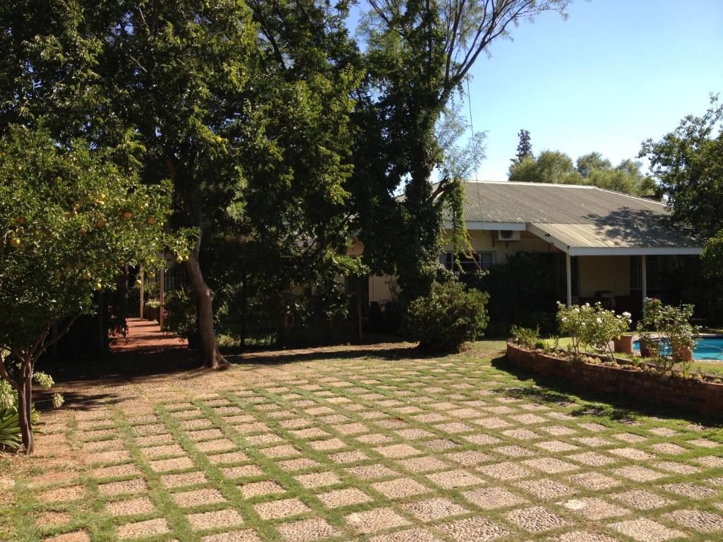 a yard with a pool and a house at The Nook B&B in Kimberley