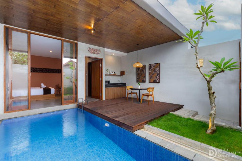 a villa with a swimming pool and a dining area at ME Villa Pererenan in Canggu