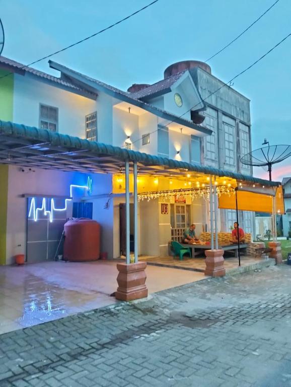a building with a patio in front of it at Villa Bukit Asri Berastagi 08 in Berastagi