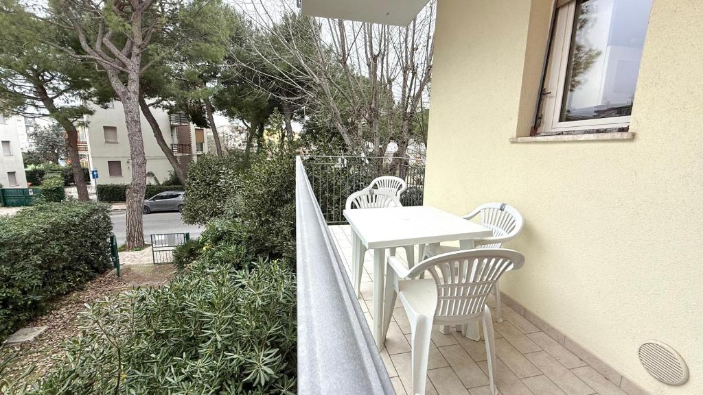 a balcony with a table and chairs on a building at M314 - Marcelli, comodo trilocale a 200mt dal mare in Marcelli