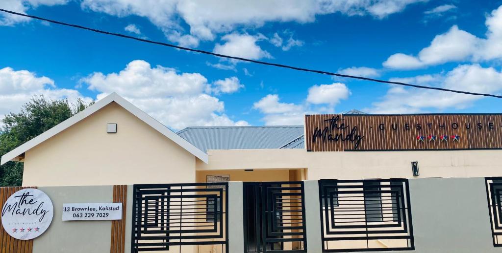 a white house with graffiti on the roof at The Mandy Guesthouse in Kokstad