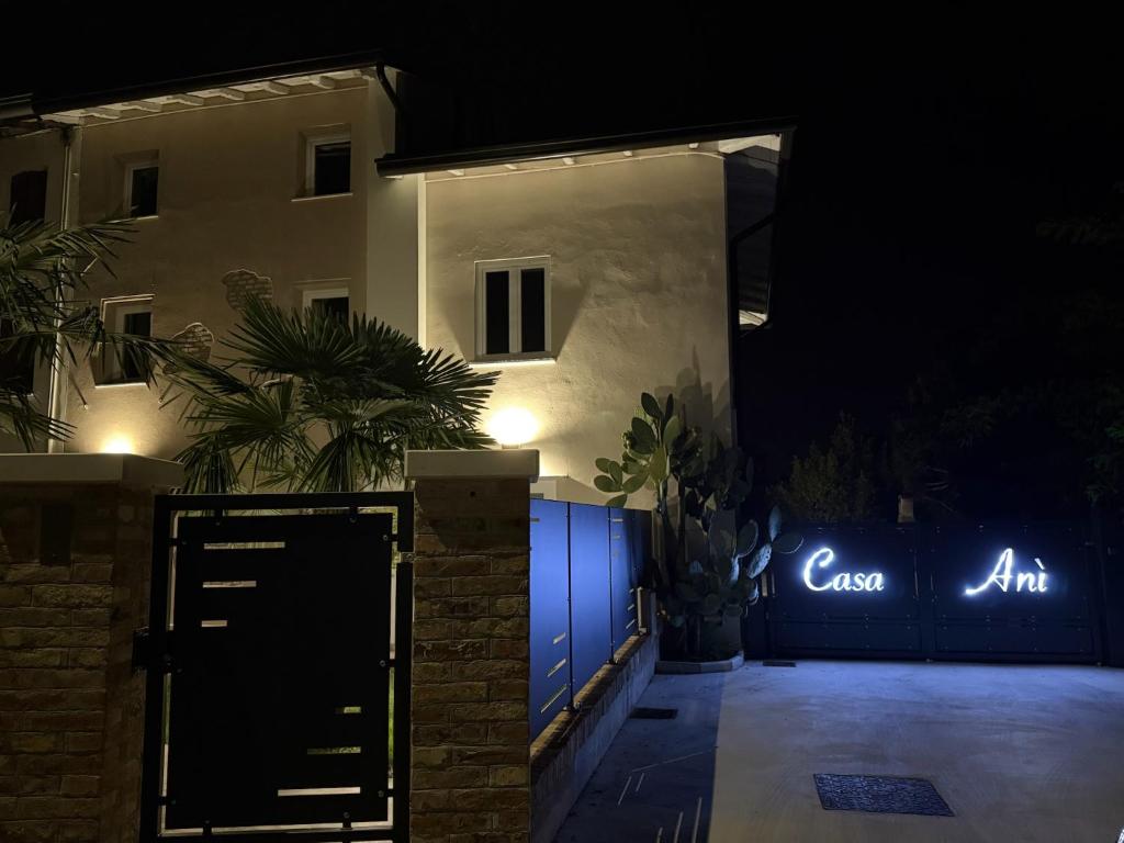 a house with a gate with a sign that reads airaan at B&B Casa Anì in Pordenone