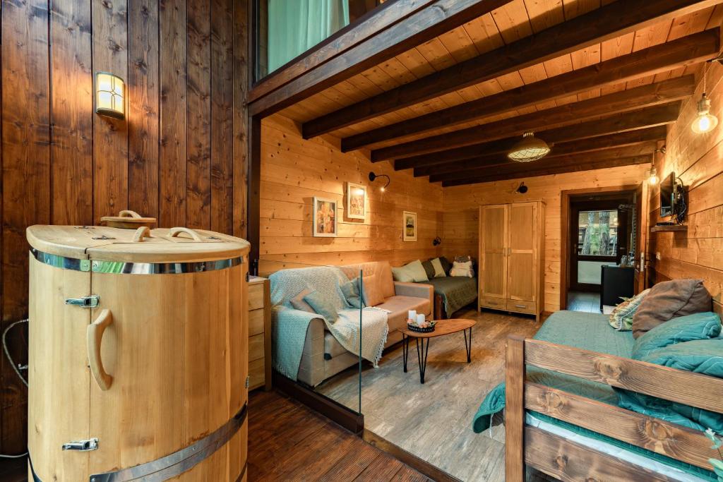 a living room with a barrel in the center of a house at PinusVillas Private Jacuzzi & Phyto-Sauna in Zheleznitsa