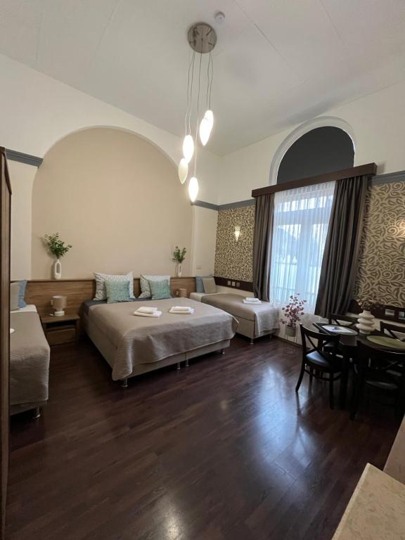 a large living room with a bed and a couch at Mohács Korona Apartman in Mohács