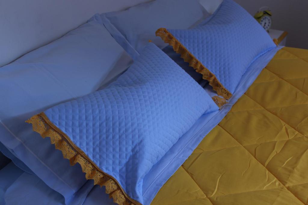 a blue bed with two pillows on top of it at Casa Nonna Teresa in Tovena