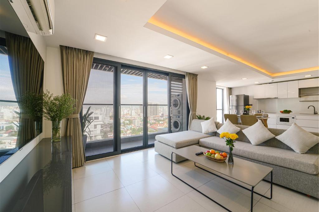 a living room with a couch and a table at Noden Hotel & Apartment in Phnom Penh