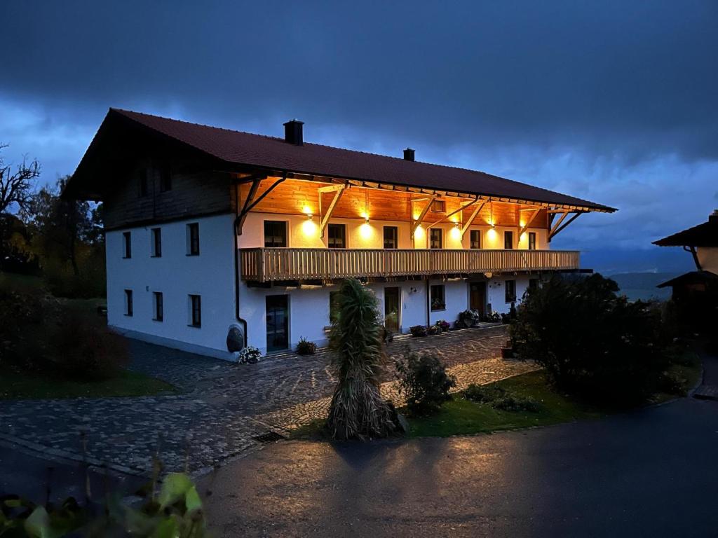 a large white building with lights on it at night at Woidzeit by Sigl in Kollnburg