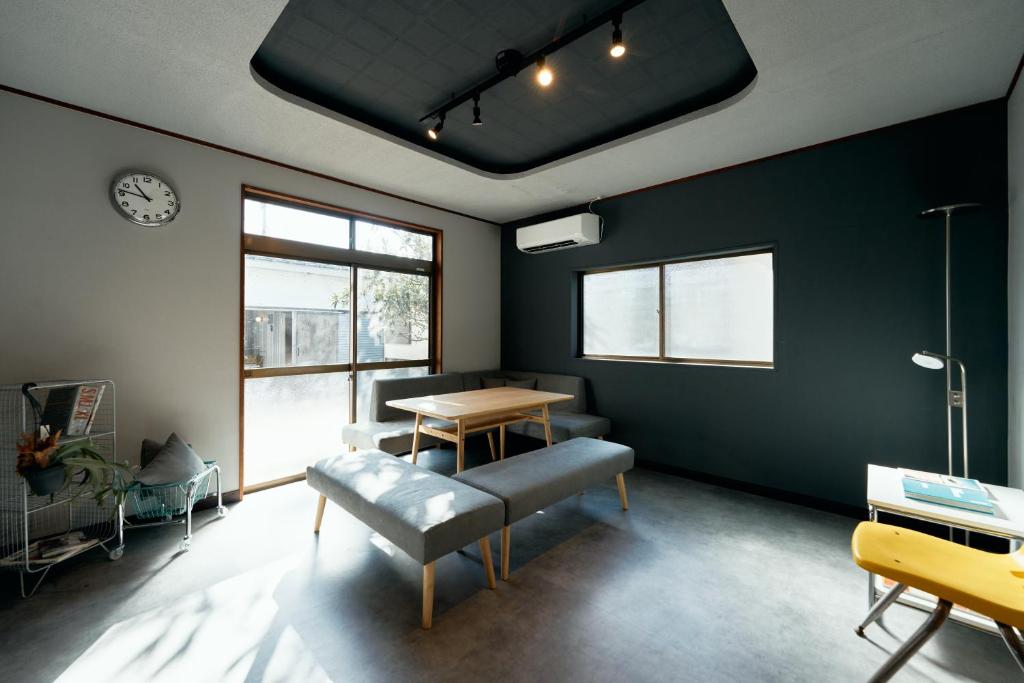 a room with a table and a bench and a table at SAUNARF Aoshima in Miyazaki