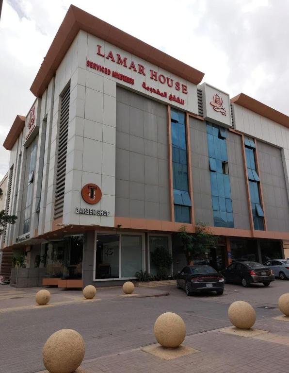 a large building with spheres in front of it at بيت لمار 3 للشقق المخدومه in Riyadh