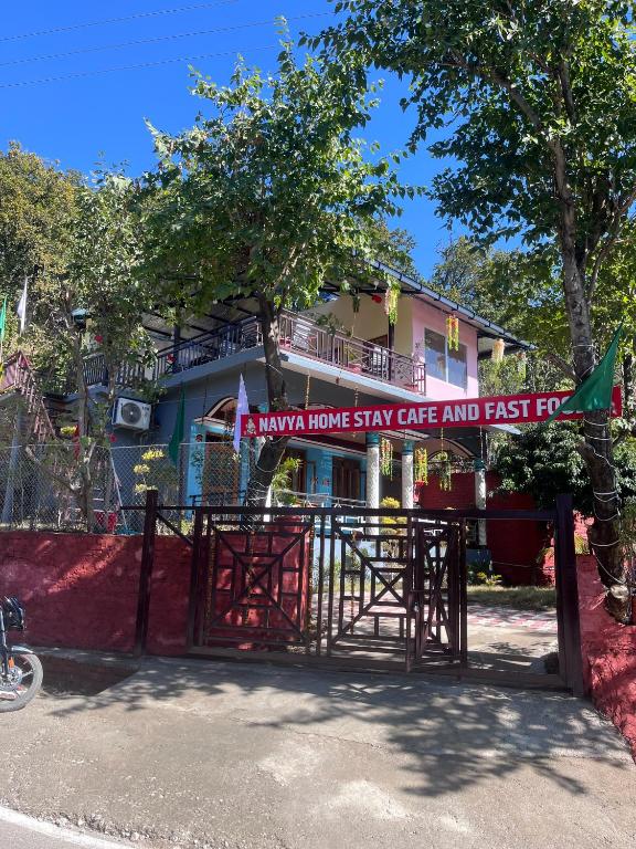 a gate with a sign that reads stay home stay safe and fast at Navya Homestay and Restaurant in Jāmb