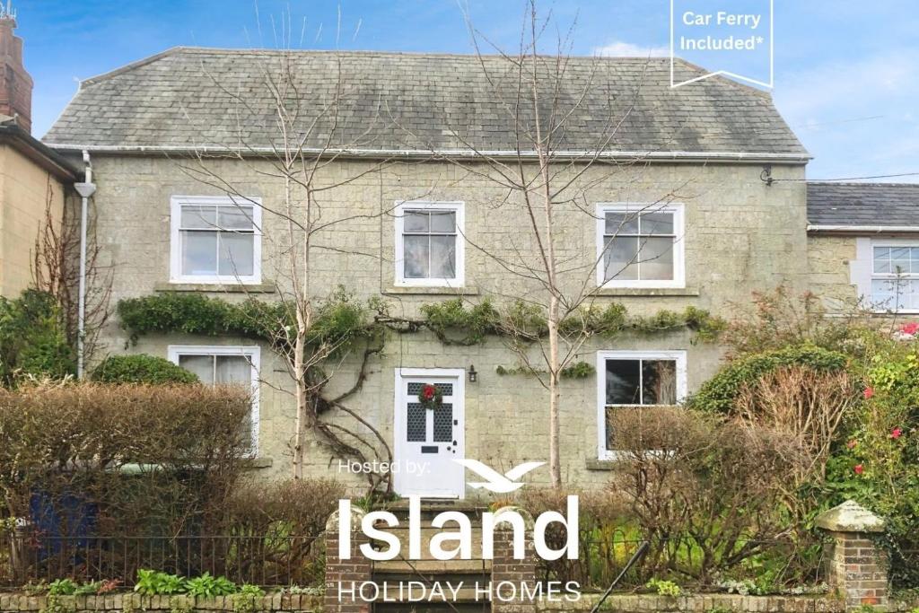 a house with a sign that reads island holiday homes at Kildare in Niton