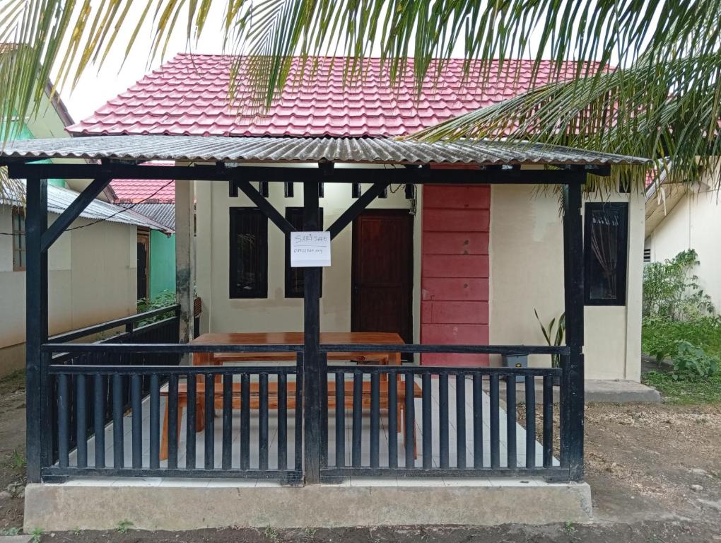a small house with a table in front of it at sarisare homestay 2BR in Bulakbenda
