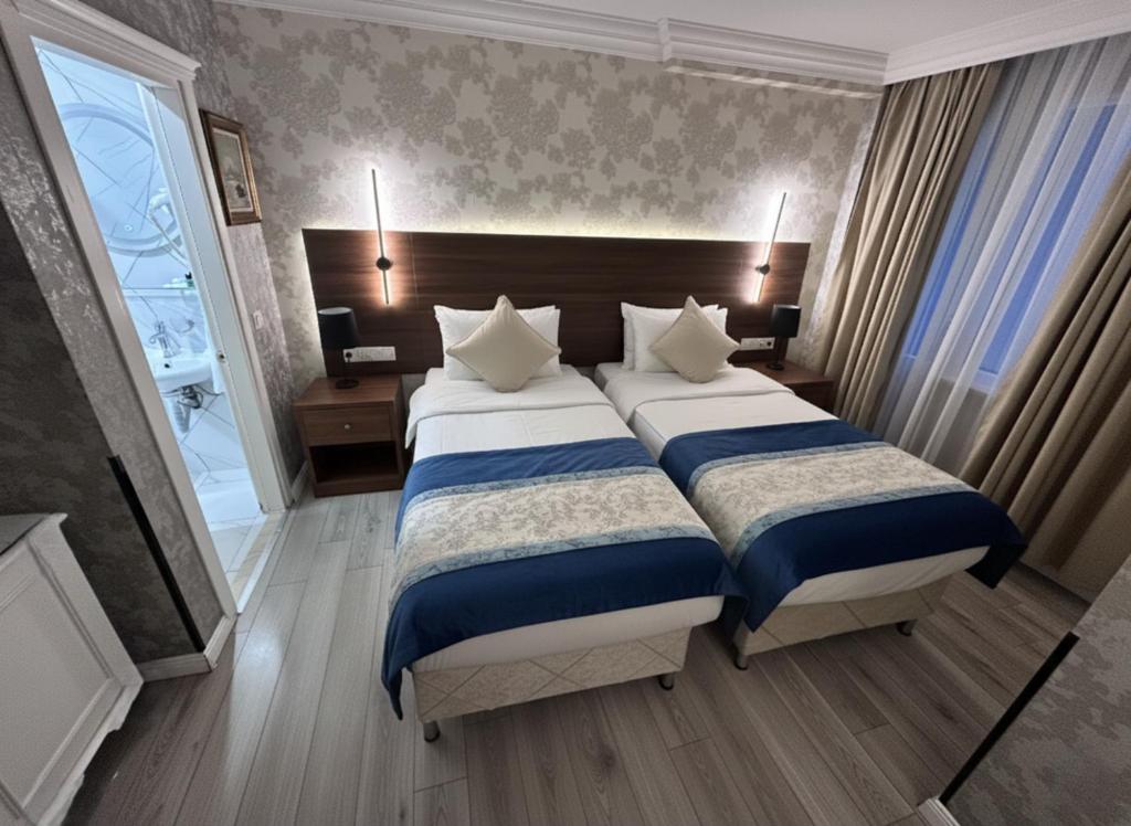 a large bedroom with two beds and a window at B Corner Hotel Bistro in Istanbul