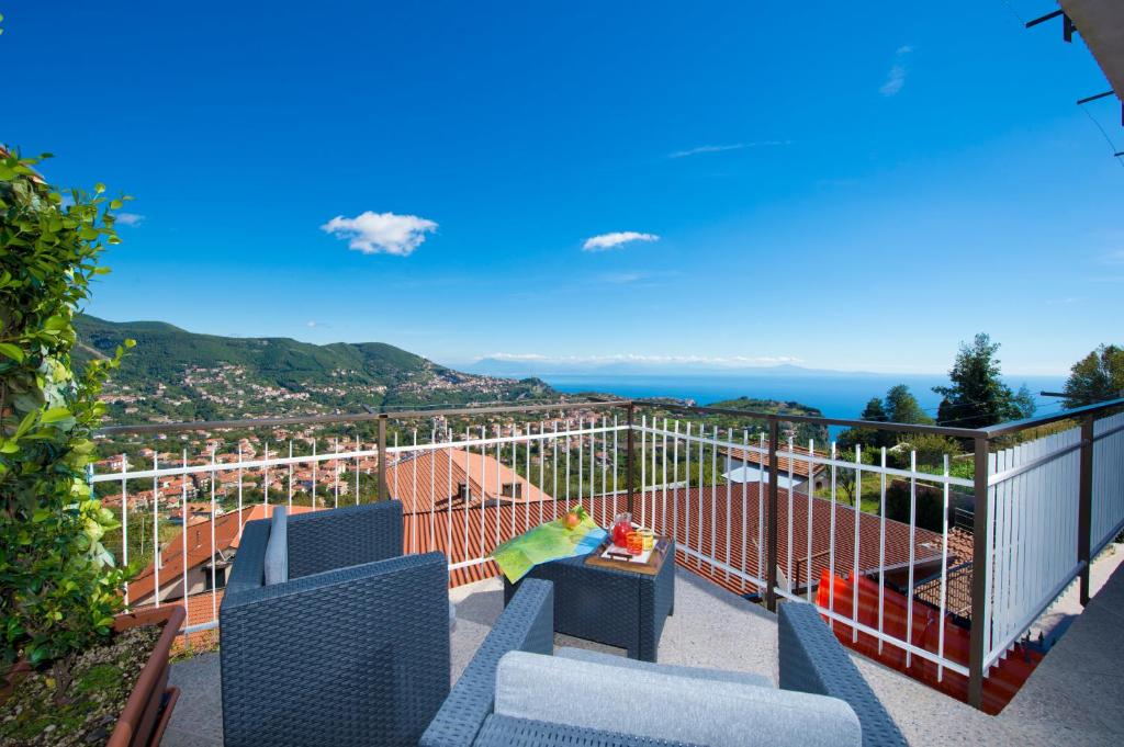 a balcony with chairs and a view of the ocean at Valle degli Dei in Agerola
