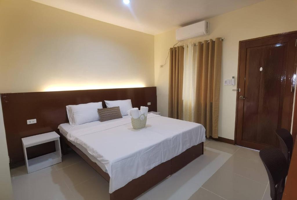a bedroom with a large bed with white sheets at Little Haven at Lio in El Nido