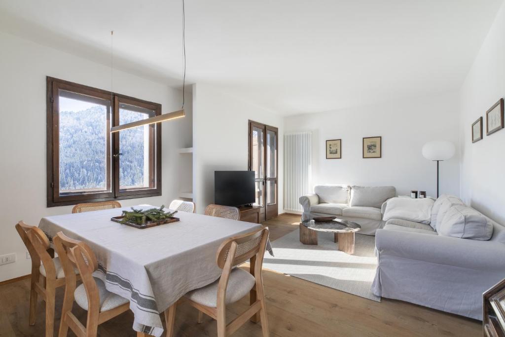 a living room with a table and a couch at Ciasa Remo 2 by WelcHome in San Vito di Cadore