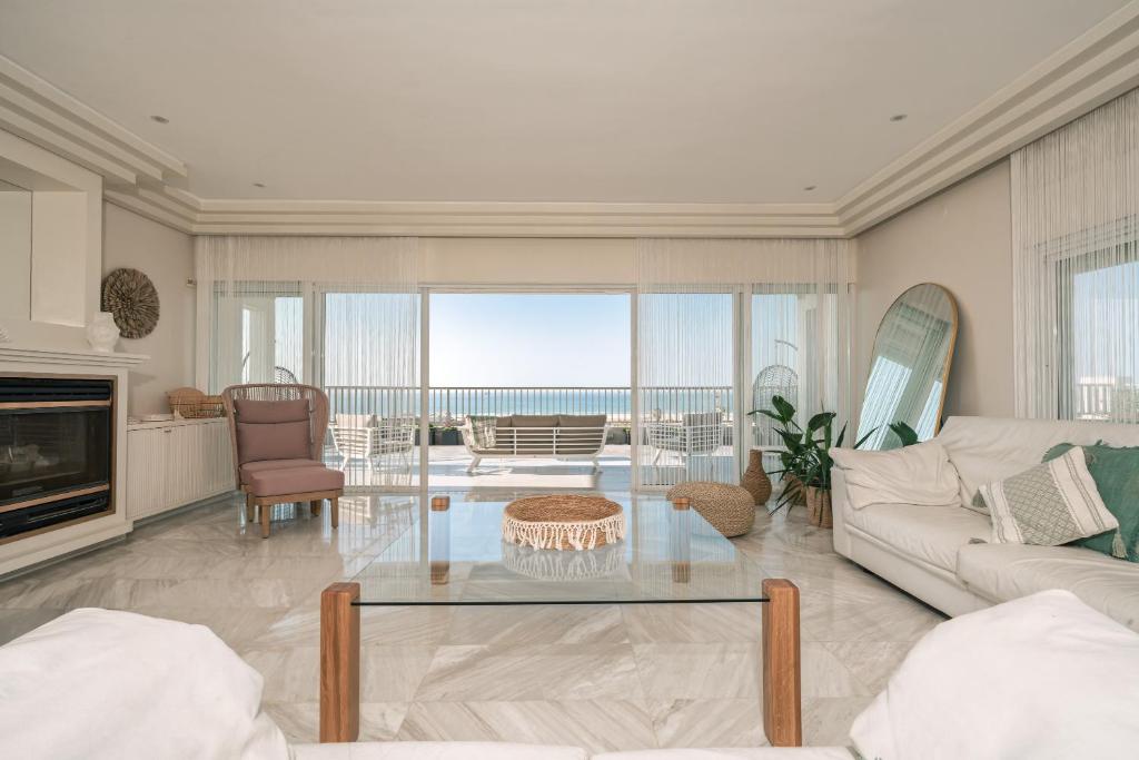 a living room with a couch and a table at Luxury Penthouse Ashdod, Sea View, 5 Bedrooms, Rooftop in Ashdod