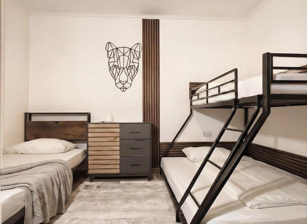 a bedroom with two bunk beds and a dresser at Zemlinsky Loft Bunk Room in Payerbach