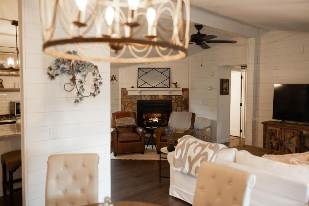 a living room with a couch and a chandelier at The Cottage at Cardinal Hill in Dahlonega