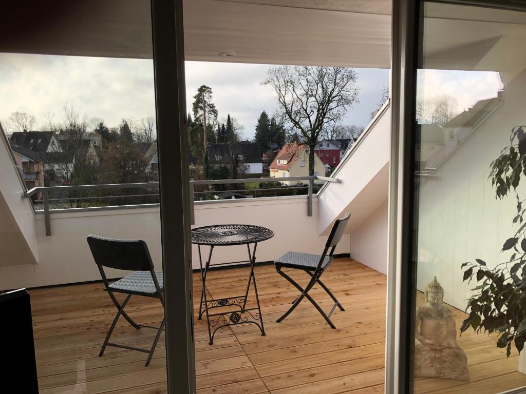 a view of a balcony with a table and chairs at Fewo extraschön - Dachgeschoss in Lindau