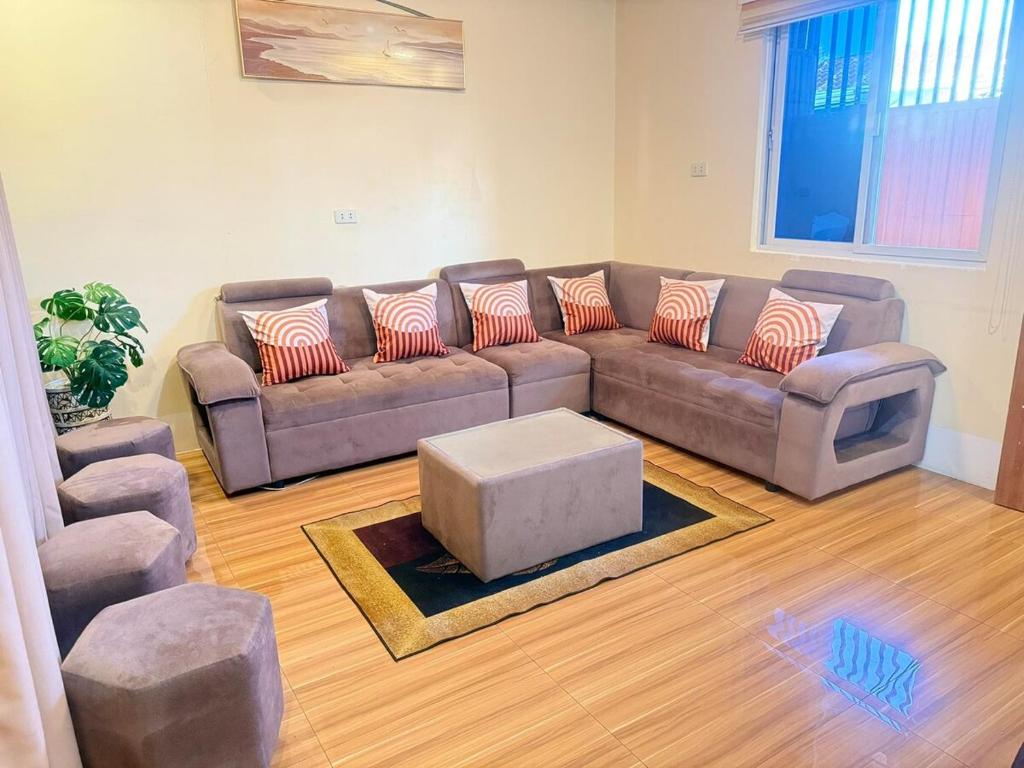a living room with a couch and a tv at Homestay in Lipa City in Lipa
