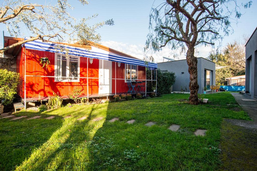 a red and white house with a tree in a yard at Atelier Randagi al Pigneto 1&2 in Rome