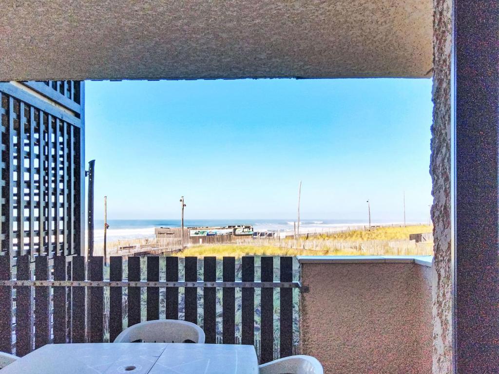 a view of the beach from a balcony with a table and chairs at Apartment Horizon Marin-2 by Interhome in Lacanau-Océan