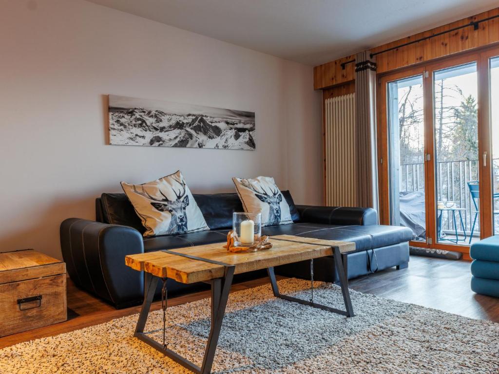 a living room with a couch and a table at Apartment Chaedoz 24-1 by Interhome in Nendaz