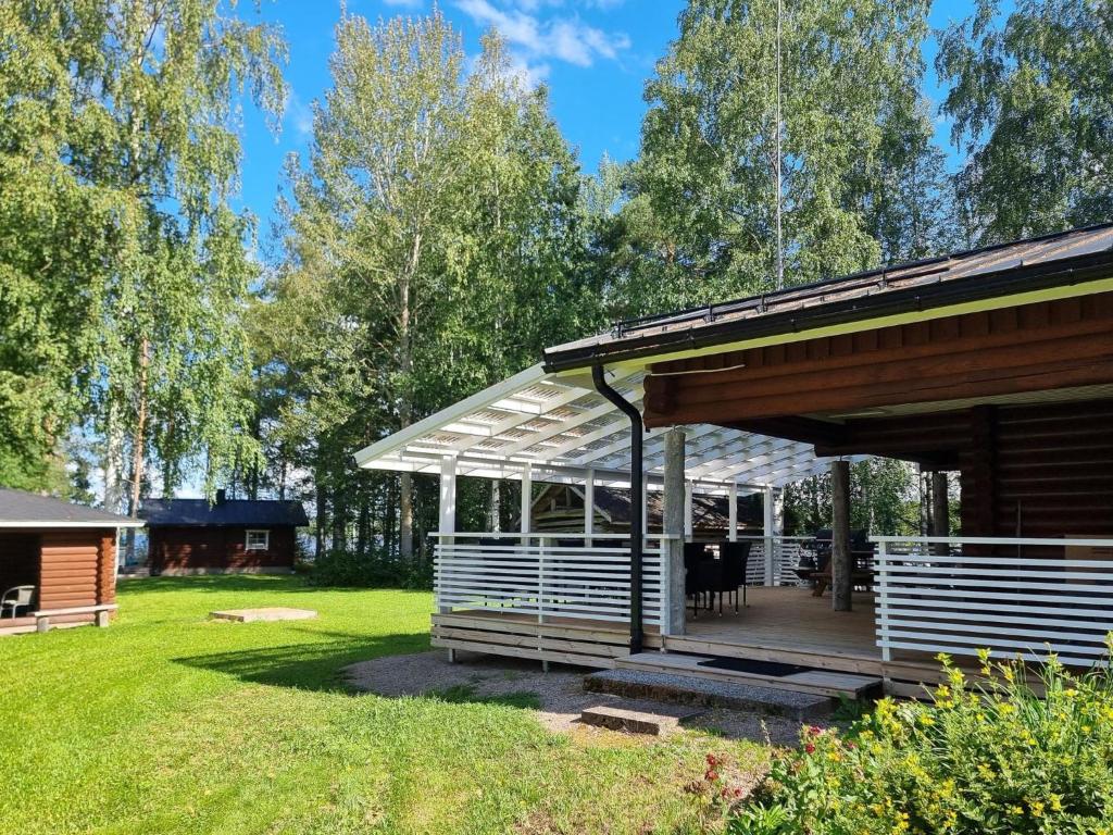 a pavilion with a deck in a yard at Holiday Home Saarenpää by Interhome in Koivisto