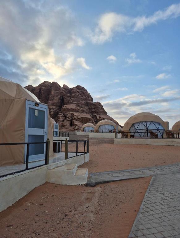 a view of a desert with a tent and a mountain at Sofia Bubble Luxury Camp in Disah