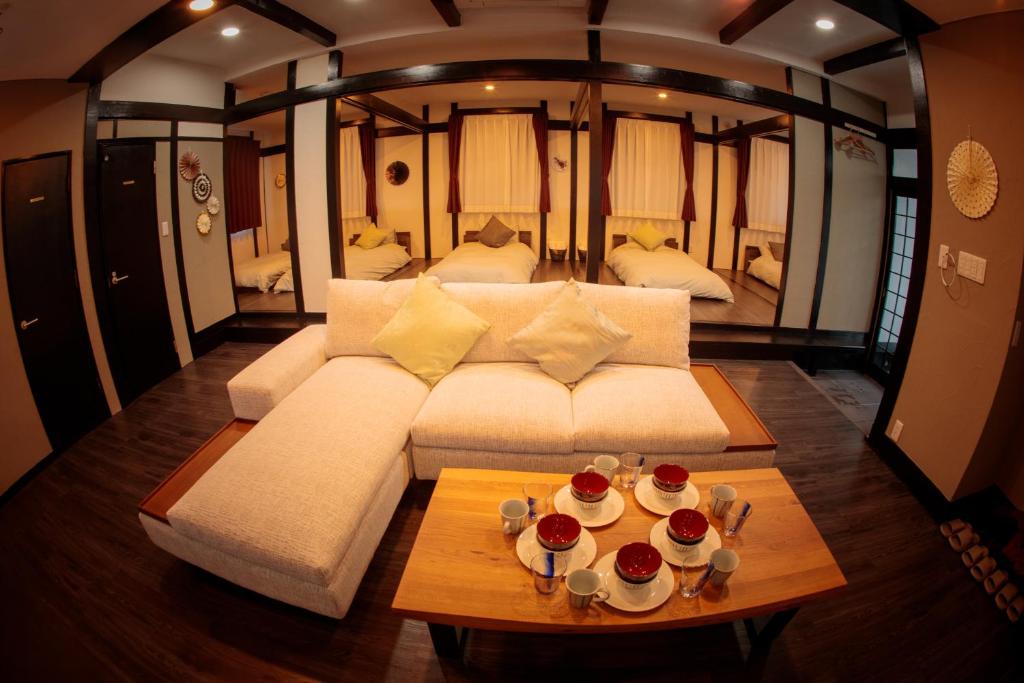 a living room with a white couch and a table at La Station in Bibai