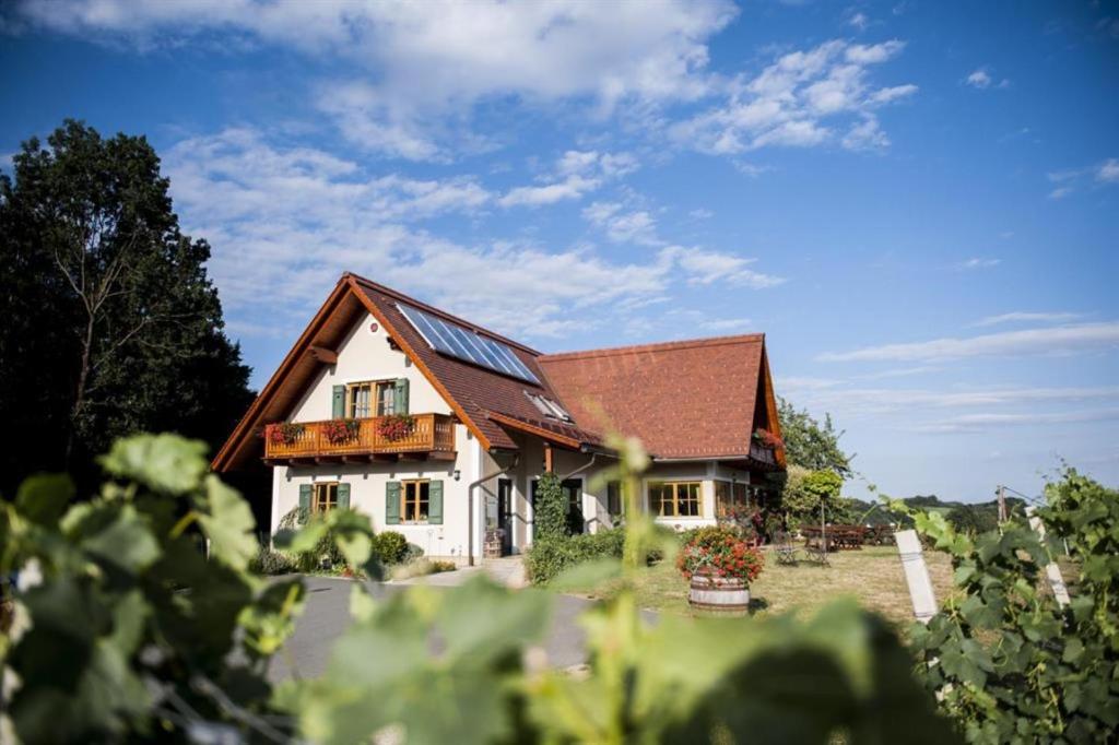 a white house with a brown roof at Gästezimmer & Weingut Gamser in Leutschach
