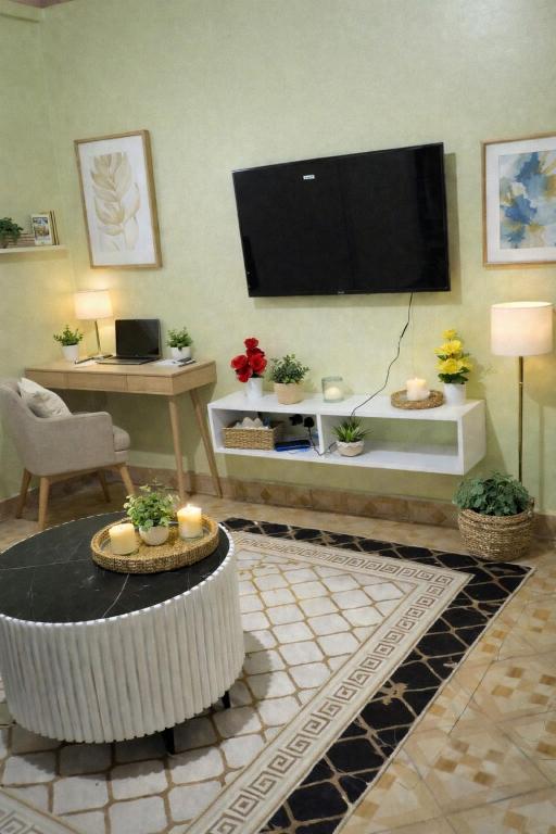 a living room with a flat screen tv on the wall at MSL Suites Apartment in Naivasha