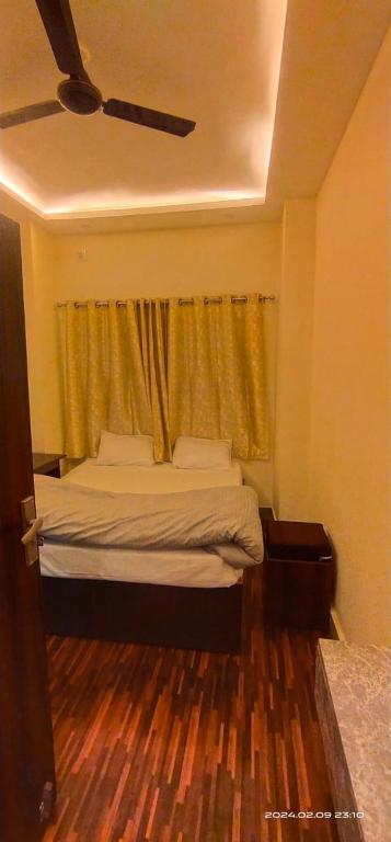 a bedroom with a bed with a curtain and a window at THE Temple View ''Near Kashi Vishwanath'' in Varanasi