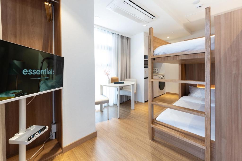 a small room with bunk beds and a tv at akastay Myeongdong in Seoul