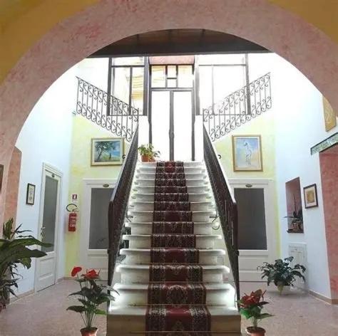 a stairway in a building with a stair case at B&B luxury San Giuseppe in Gerace