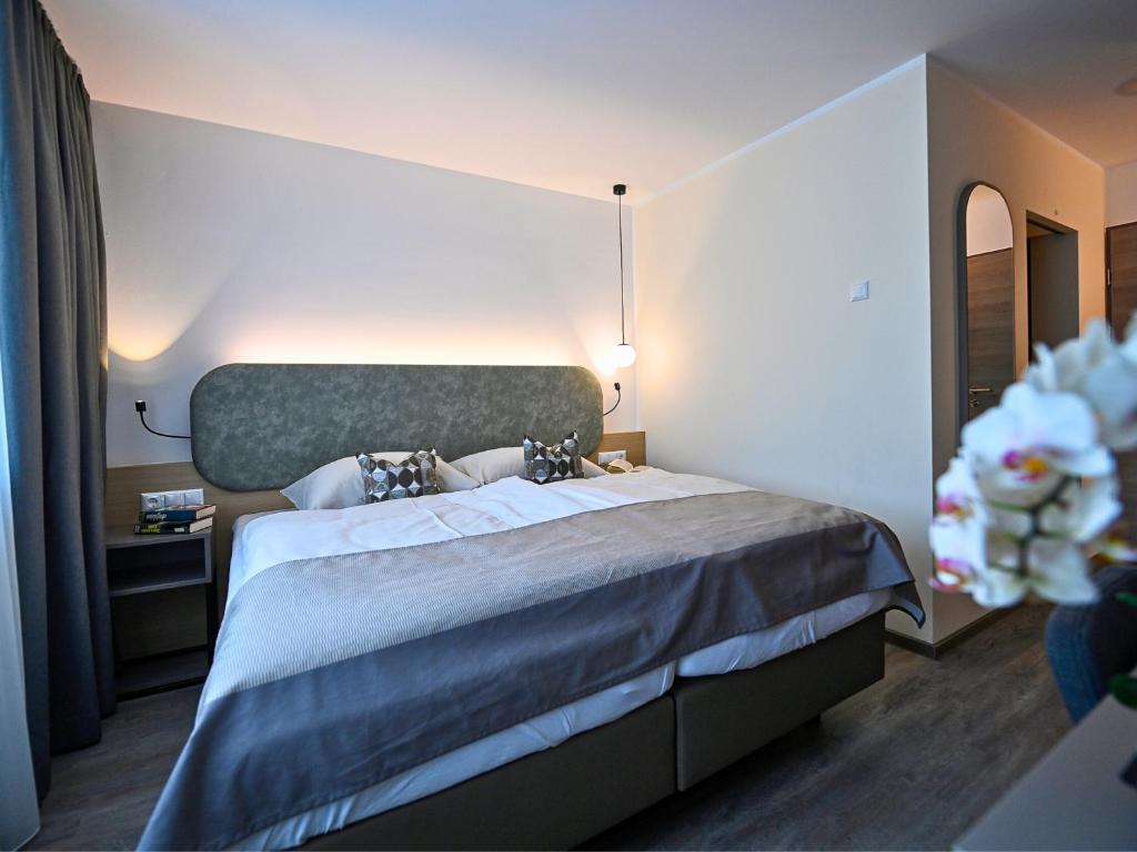 a bedroom with a large bed in a room at Kolping Gästehaus in Klagenfurt