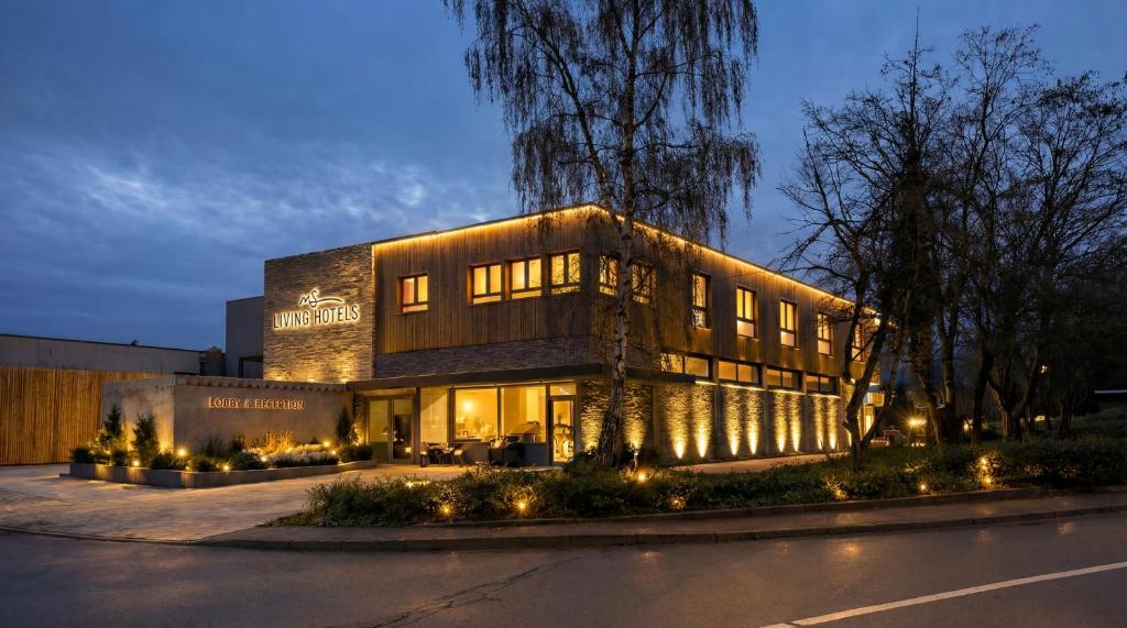 a building with lights on the side of a street at MSLiving Hotels in Hannover