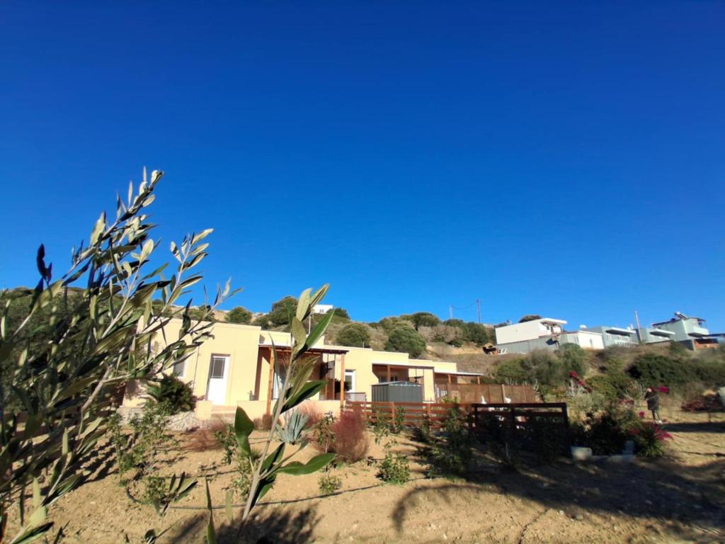 a house on the side of a hill in the desert at Anthos Residence 1 in Kefalos