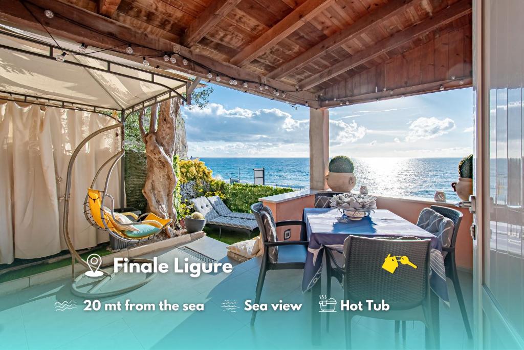 two people sitting at a table looking out at the ocean at SEAHORSEROOM - Frontemare con Idromassaggio in Finale Ligure