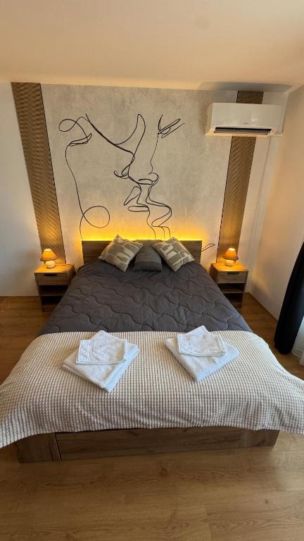 a bedroom with a bed with two towels on it at Aspen Golf Resort Studio E206 in Bansko