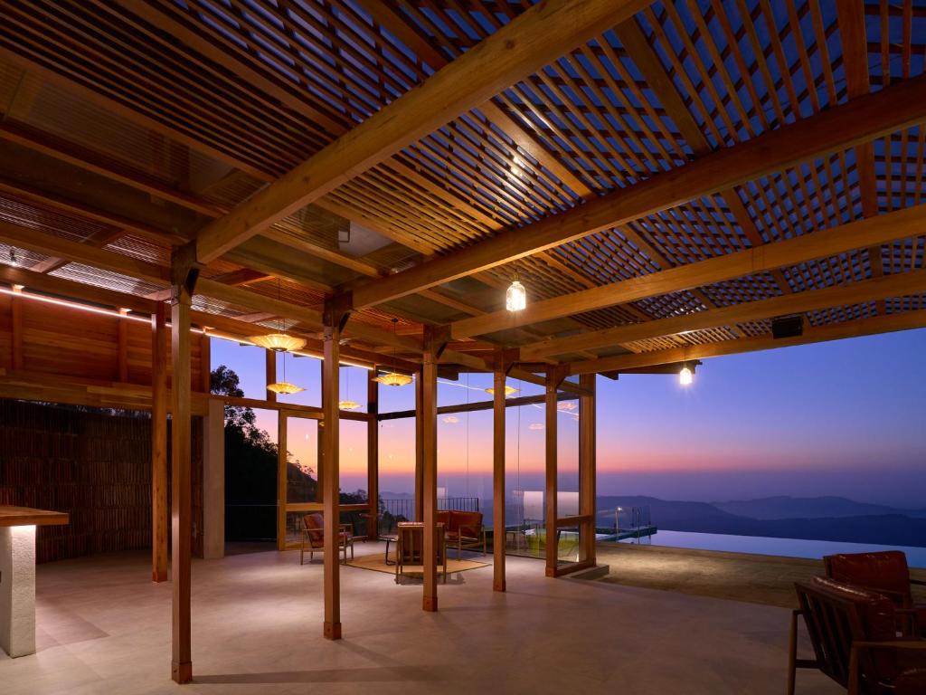a wooden pavilion with a view of the ocean at Wishing Tree Boutique Resort and Spa - Haputale's Panoramic Hideaway in Haputale